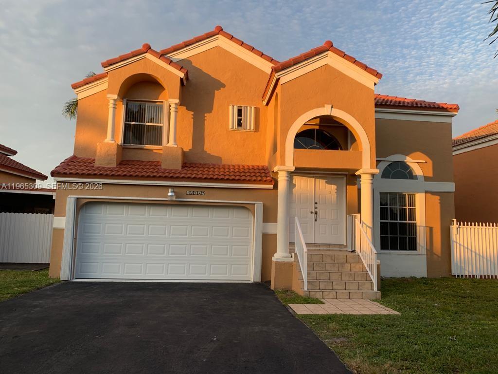 12447 Northwest 7th Street Miami, FL 33172 - Photo 1 of 29 a front view of a house with a yard