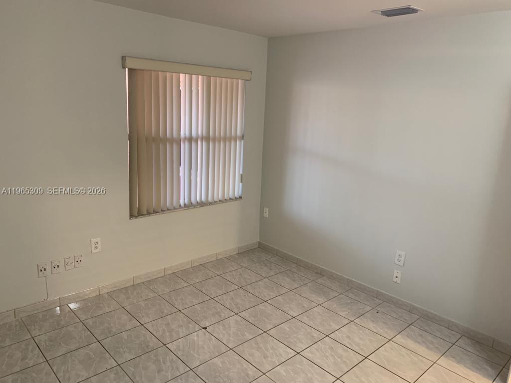 12447 Northwest 7th Street Miami, FL 33172 - Photo 11 of 29 an empty room with windows