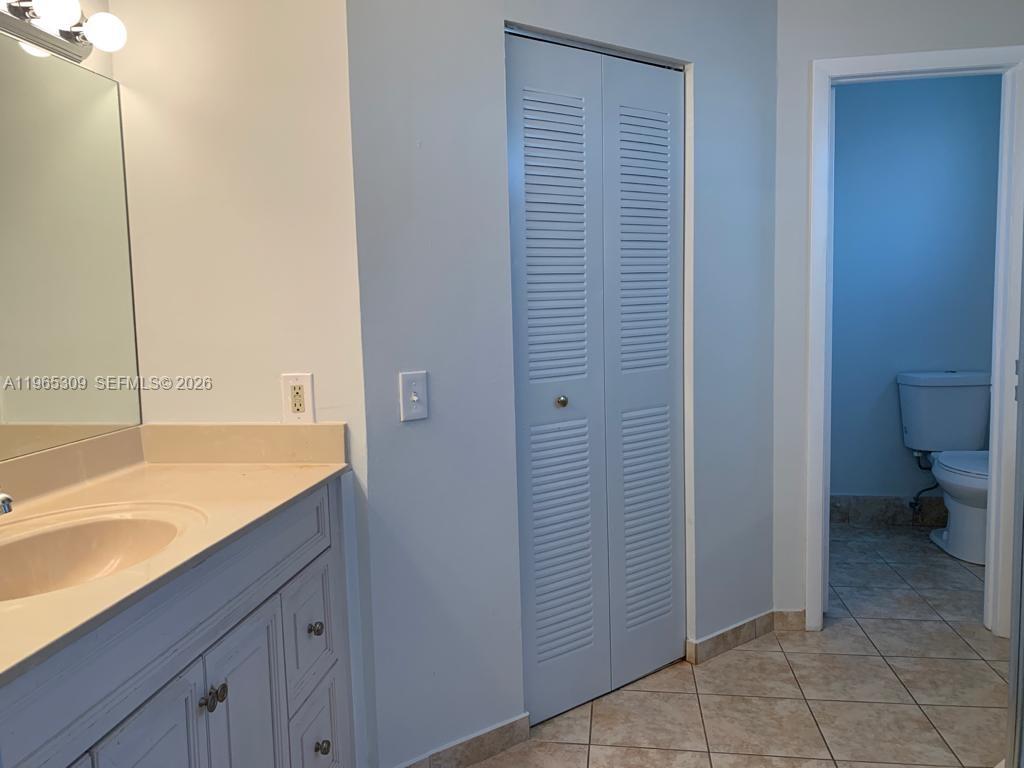12447 Northwest 7th Street Miami, FL 33172 - Photo 14 of 29 a bathroom with a granite countertop sink and toilet