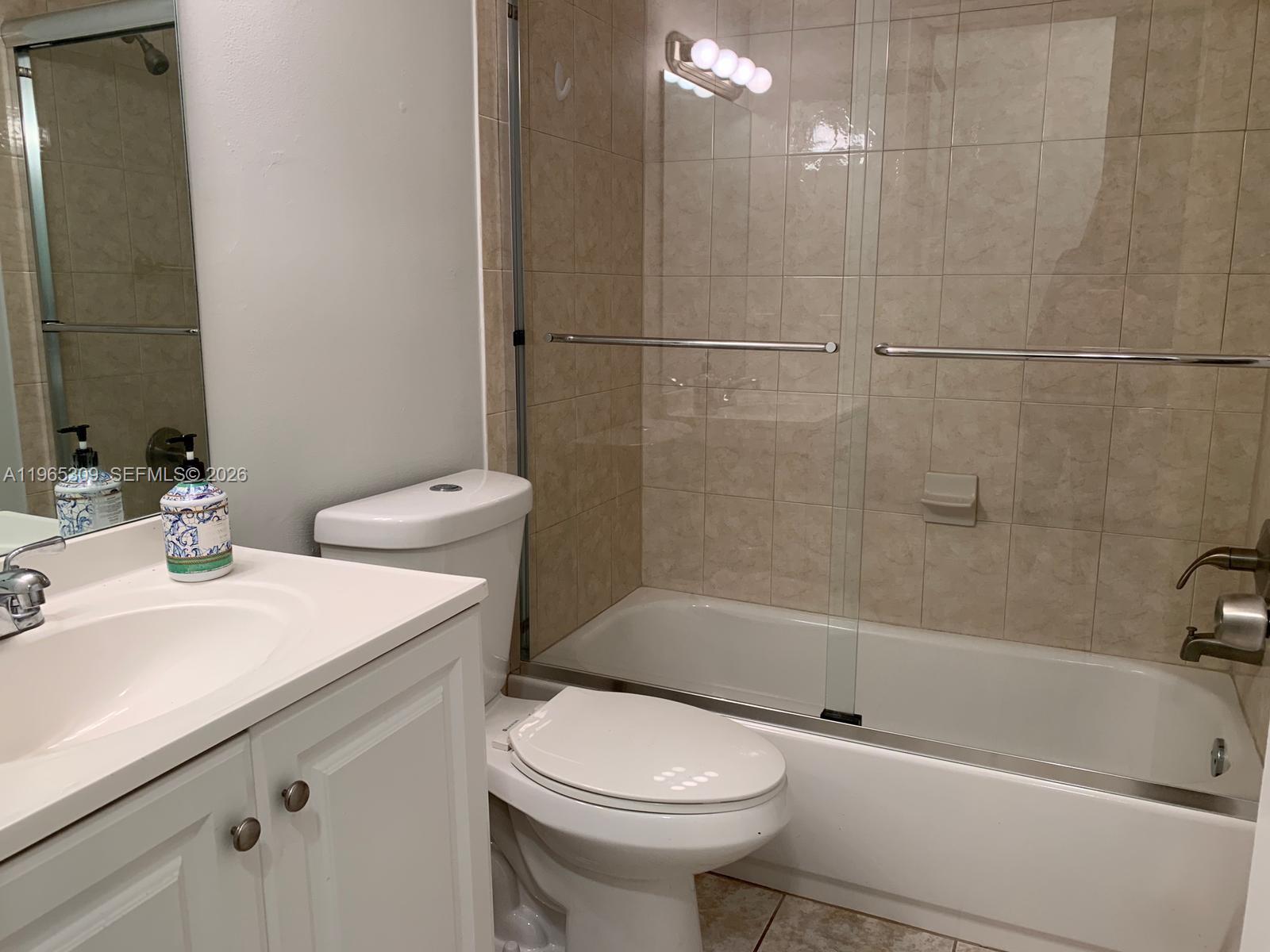12447 Northwest 7th Street Miami, FL 33172 - Photo 16 of 29 a bathroom with a sink a toilet and a bathtub