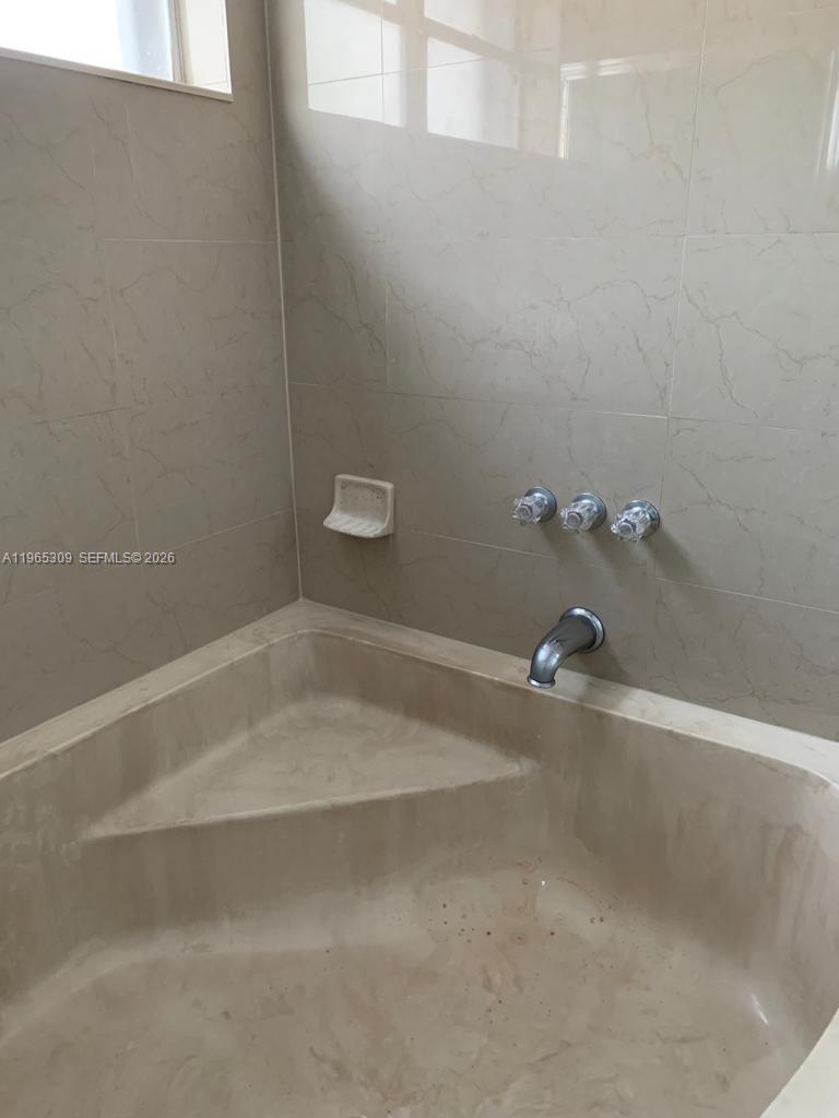 12447 Northwest 7th Street Miami, FL 33172 - Photo 17 of 29 a close up of a bathtub