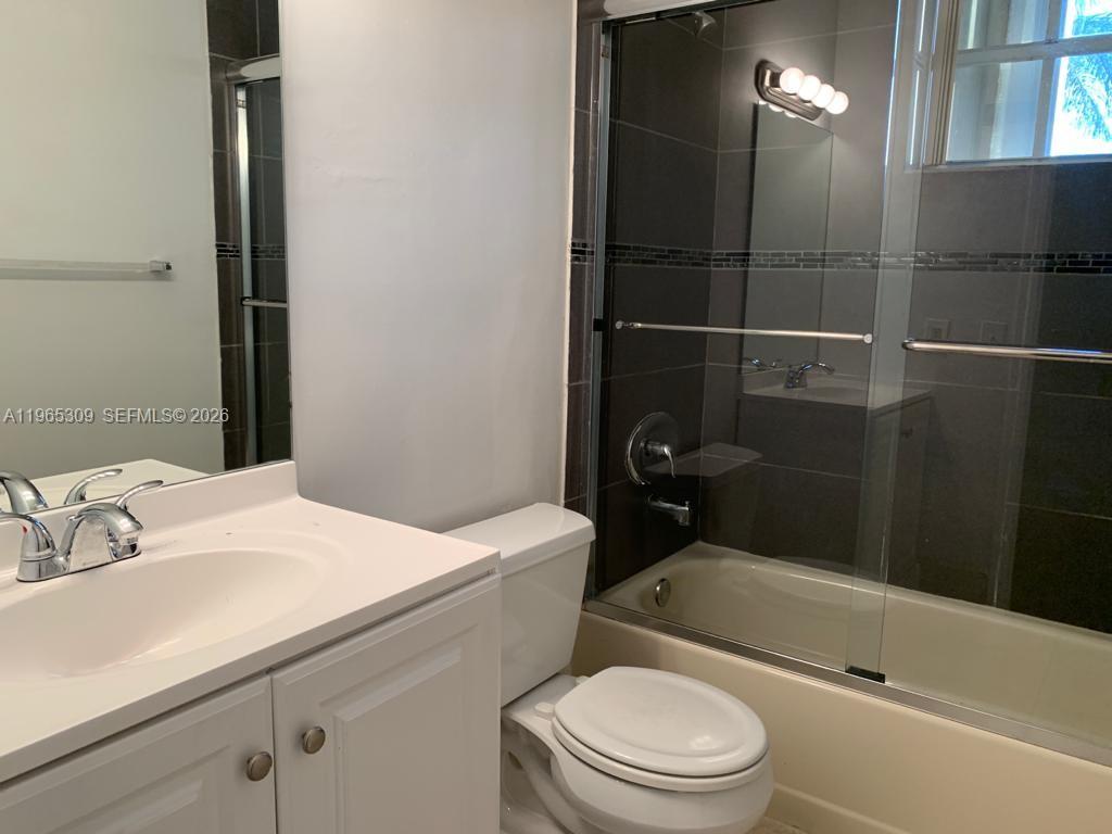 12447 Northwest 7th Street Miami, FL 33172 - Photo 23 of 29 a bathroom with a sink a toilet and shower
