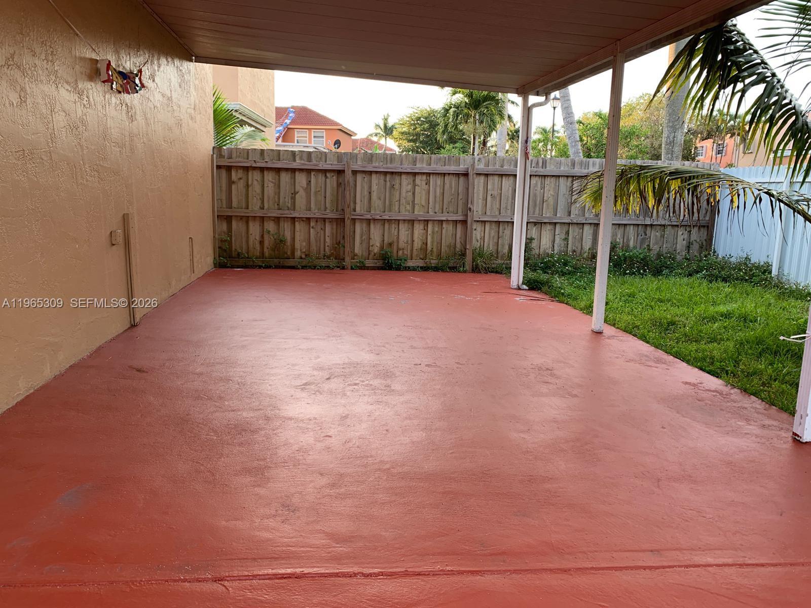 12447 Northwest 7th Street Miami, FL 33172 - Photo 28 of 29 a view of a backyard with a large tree