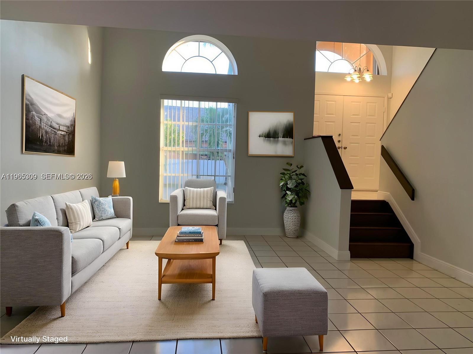 12447 Northwest 7th Street Miami, FL 33172 - Photo 4 of 29 a living room with furniture and a chandelier