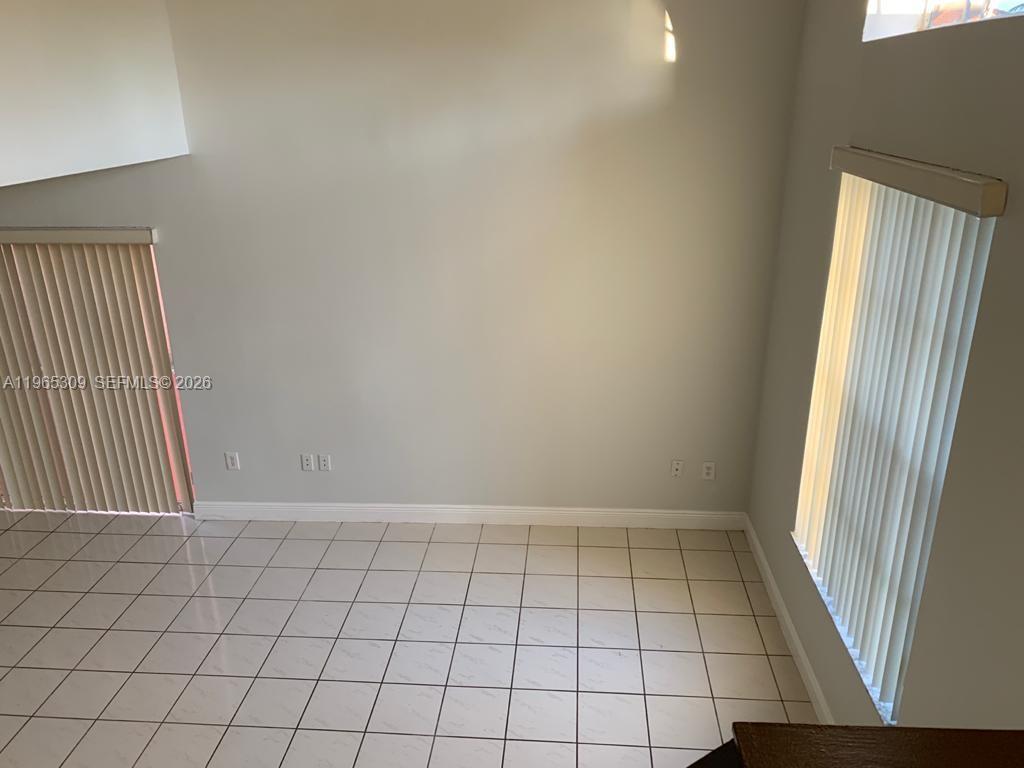 12447 Northwest 7th Street Miami, FL 33172 - Photo 9 of 29 an empty room with windows
