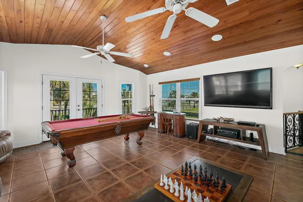 a living room with patio furniture and a flat screen tv