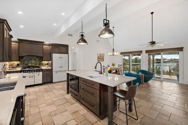 a kitchen with stainless steel appliances a sink a counter top space appliances and cabinets