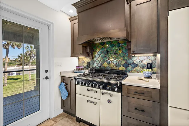 a kitchen with stainless steel appliances white cabinets and a stove
