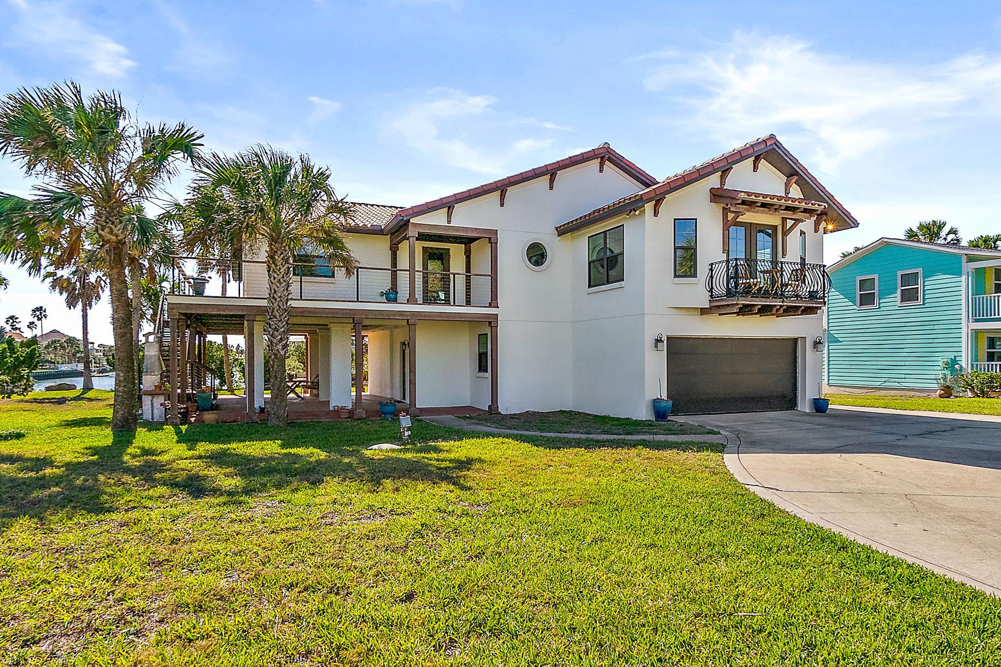 8851 South A1a Street St. Augustine, FL 32080 - Photo 2 of 50 a front view of a house with a yard and swimming pool