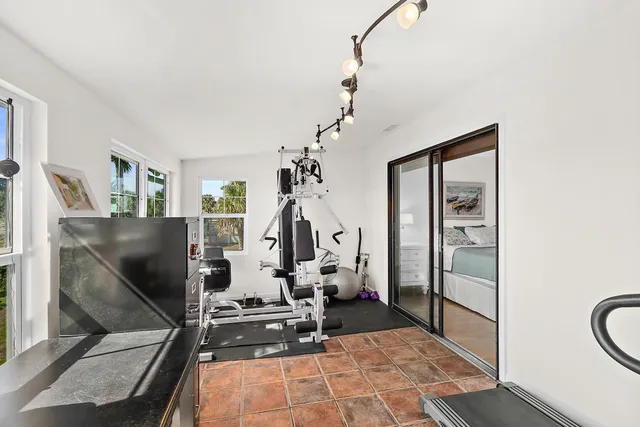 a room with gym equipment and windows