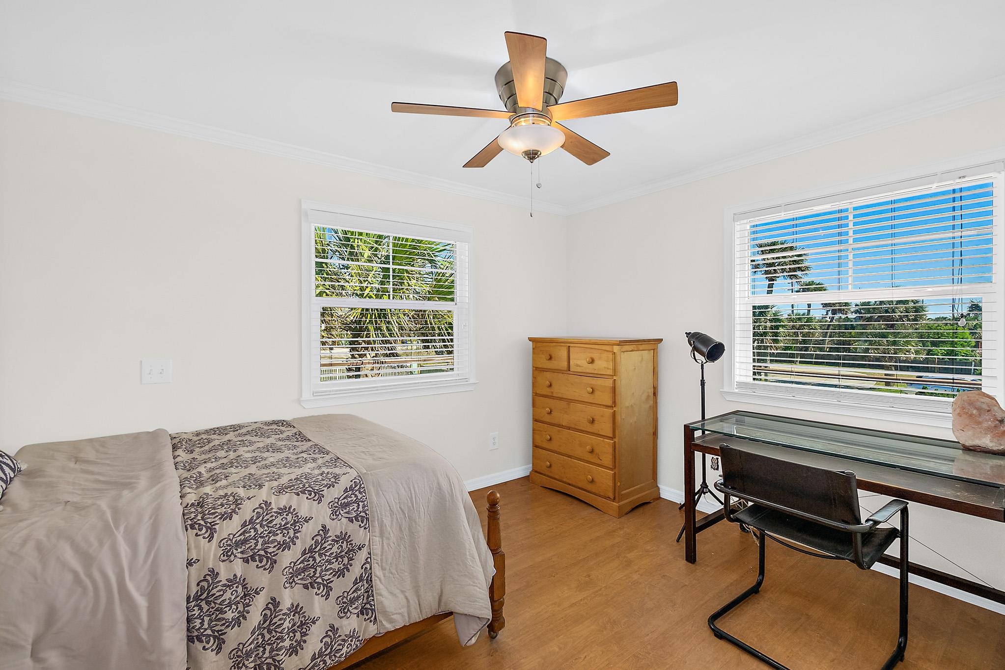 8851 South A1a Street St. Augustine, FL 32080 - Photo 31 of 50 a bedroom with a bed and a chandelier