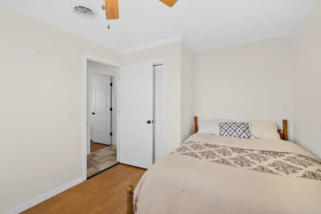 a bedroom with a bed and a mirror