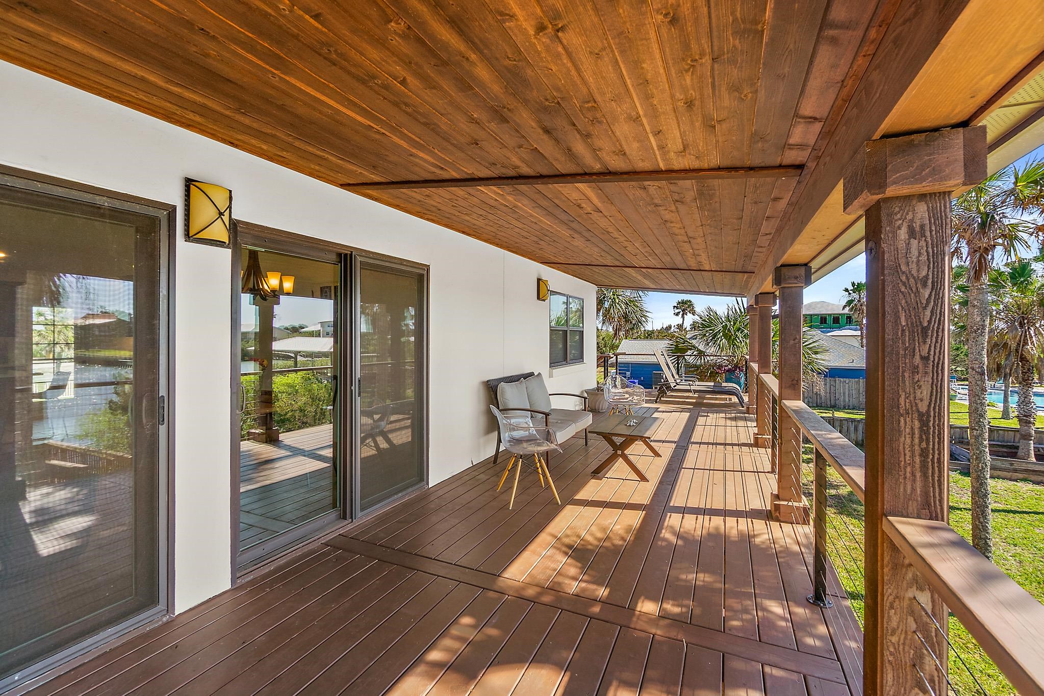 8851 South A1a Street St. Augustine, FL 32080 - Photo 39 of 50 a patio with yard glass top table and chairs