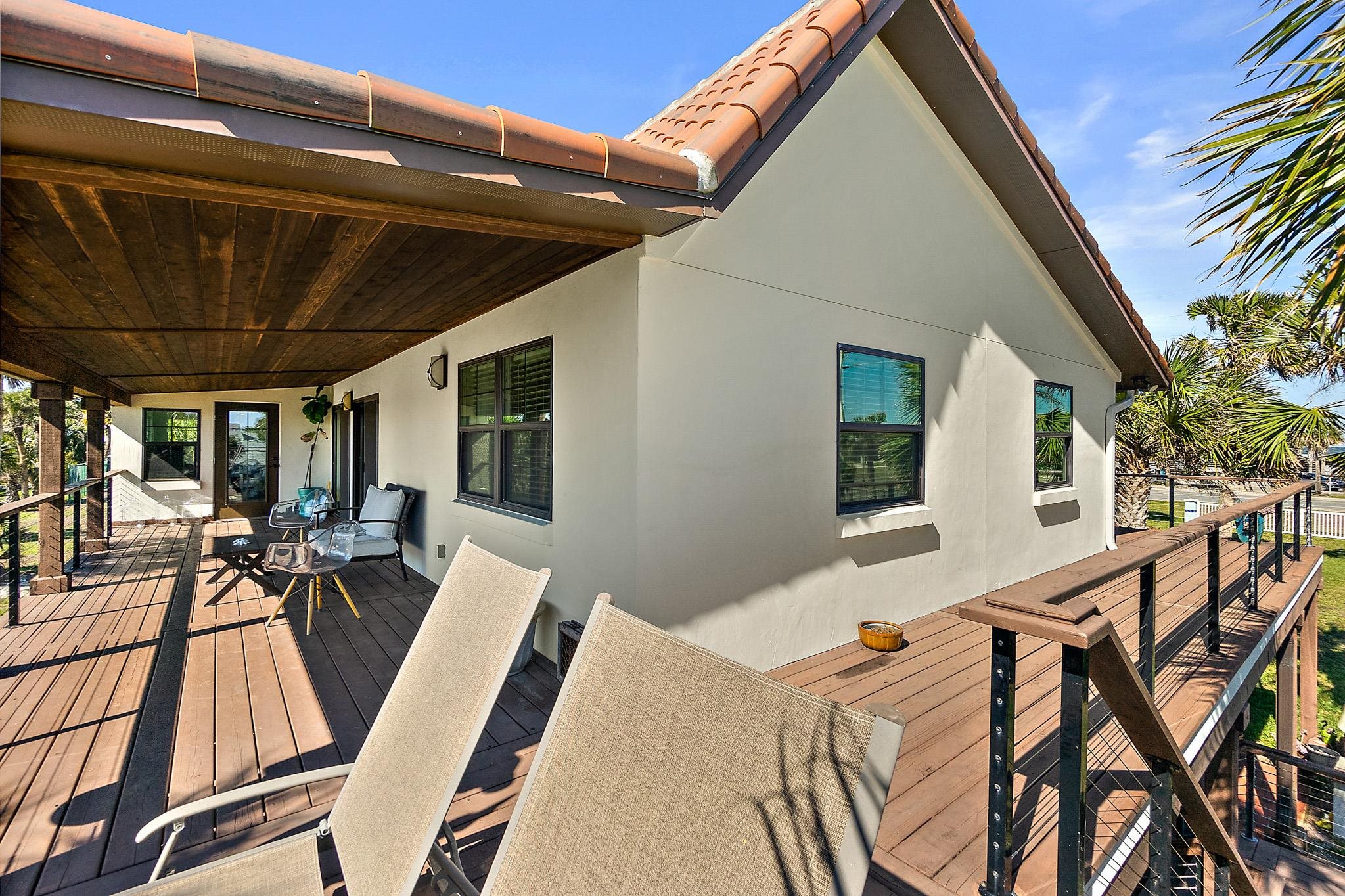 8851 South A1a Street St. Augustine, FL 32080 - Photo 40 of 50 a view of a patio with table and chairs with wooden floor and fence