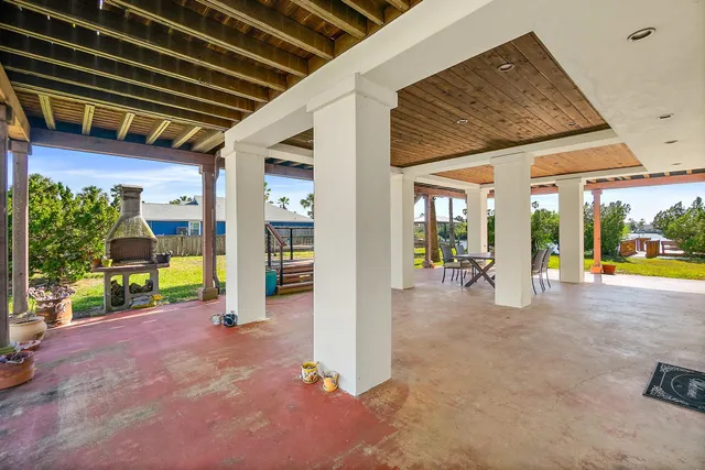 a view of a dining room with furniture a chandelier and wooden floor
