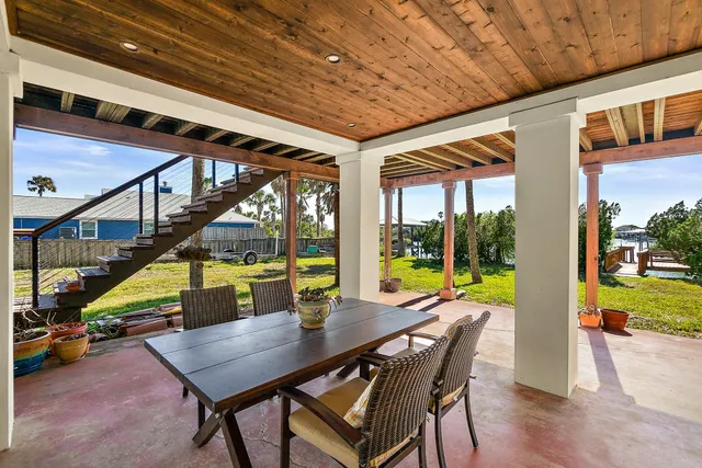a swimming pool with outdoor seating and yard