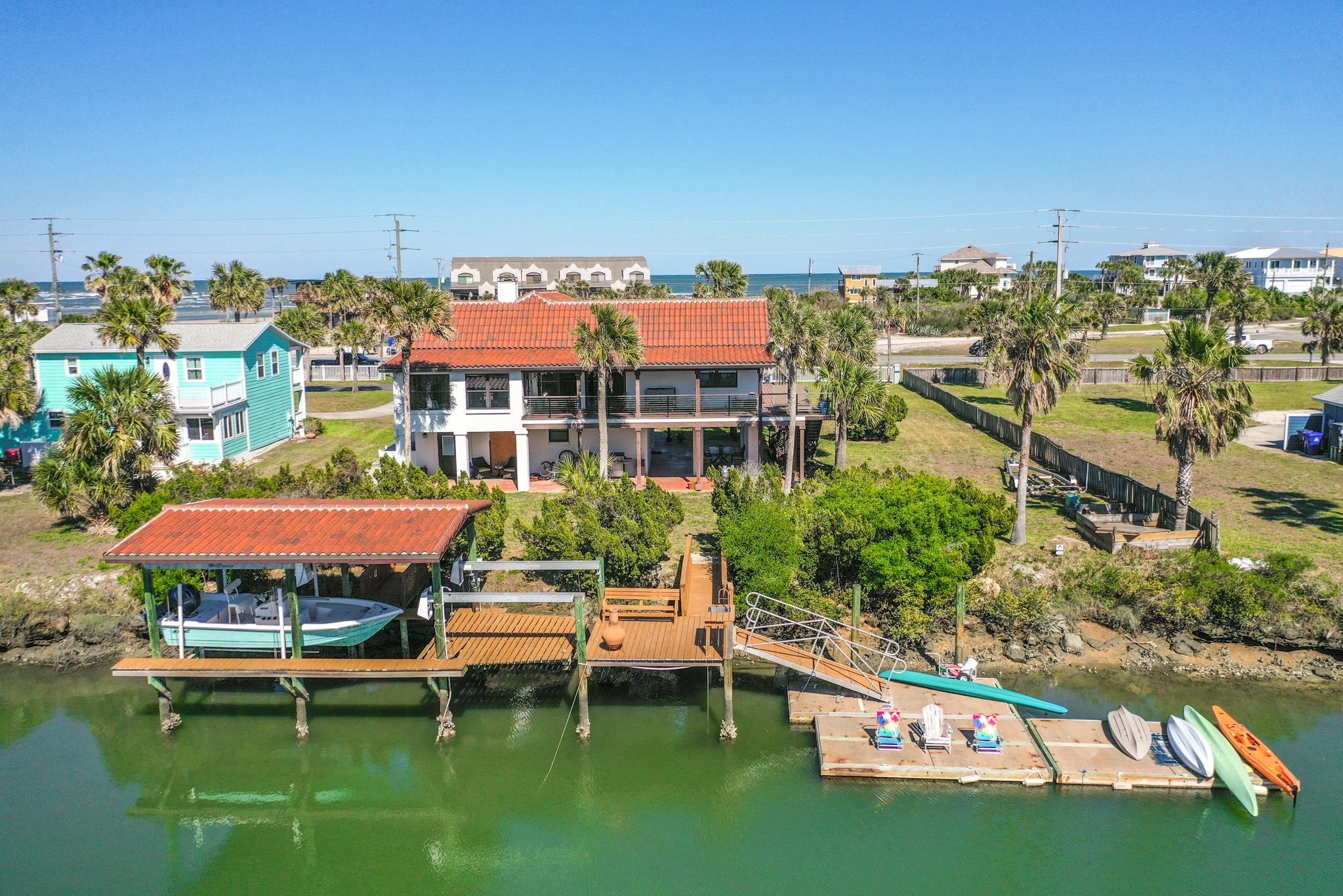 8851 South A1a Street St. Augustine, FL 32080 - Photo 46 of 50 a swimming pool with outdoor seating and yard