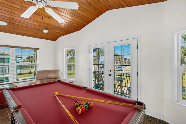 a living room with furniture pool table and a window