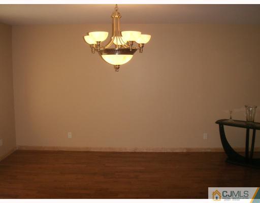 10 Middlesex Road Matawan, NJ 07747 - Photo 4 of 8 a view of a room with water heater and wooden floor
