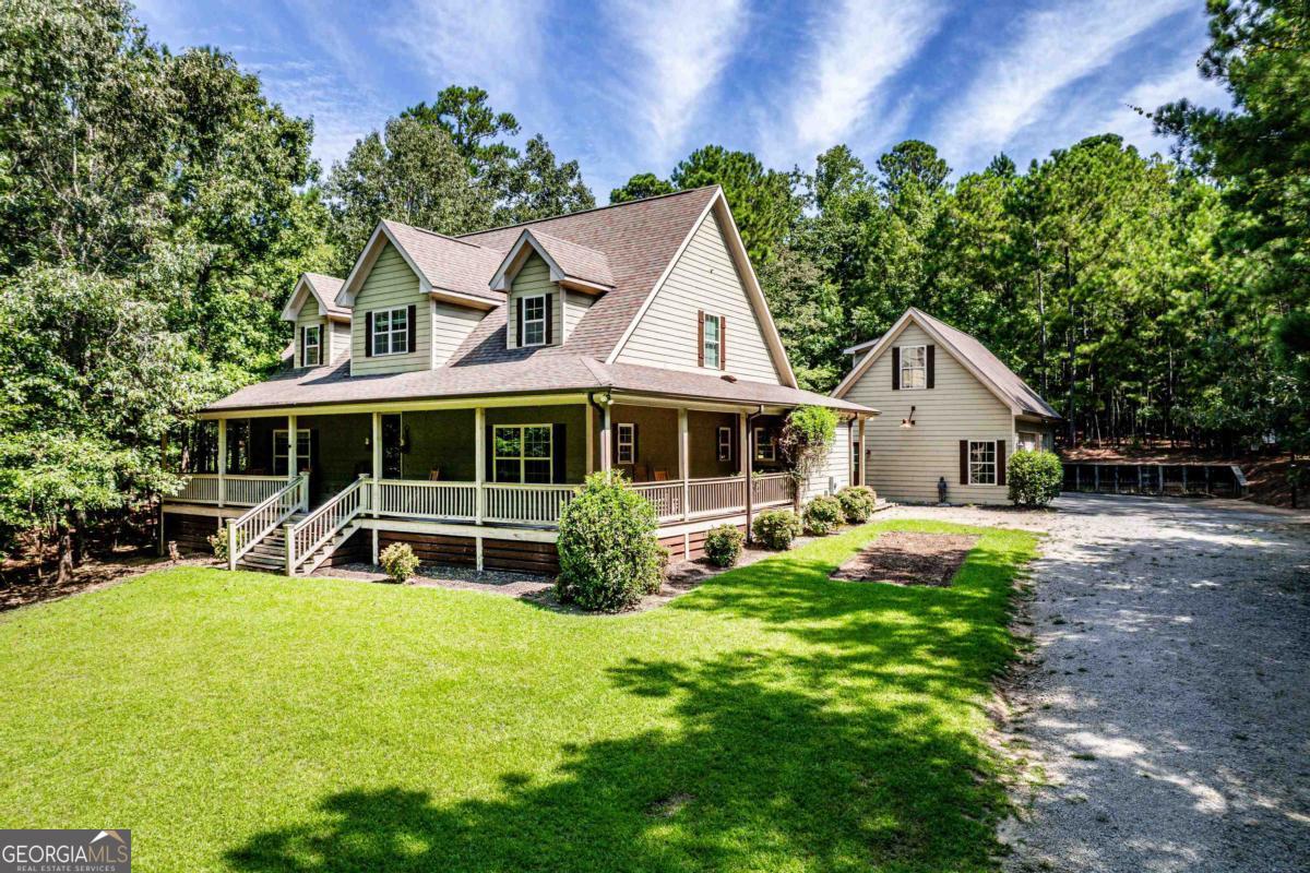a view of a house with a yard patio and a garden