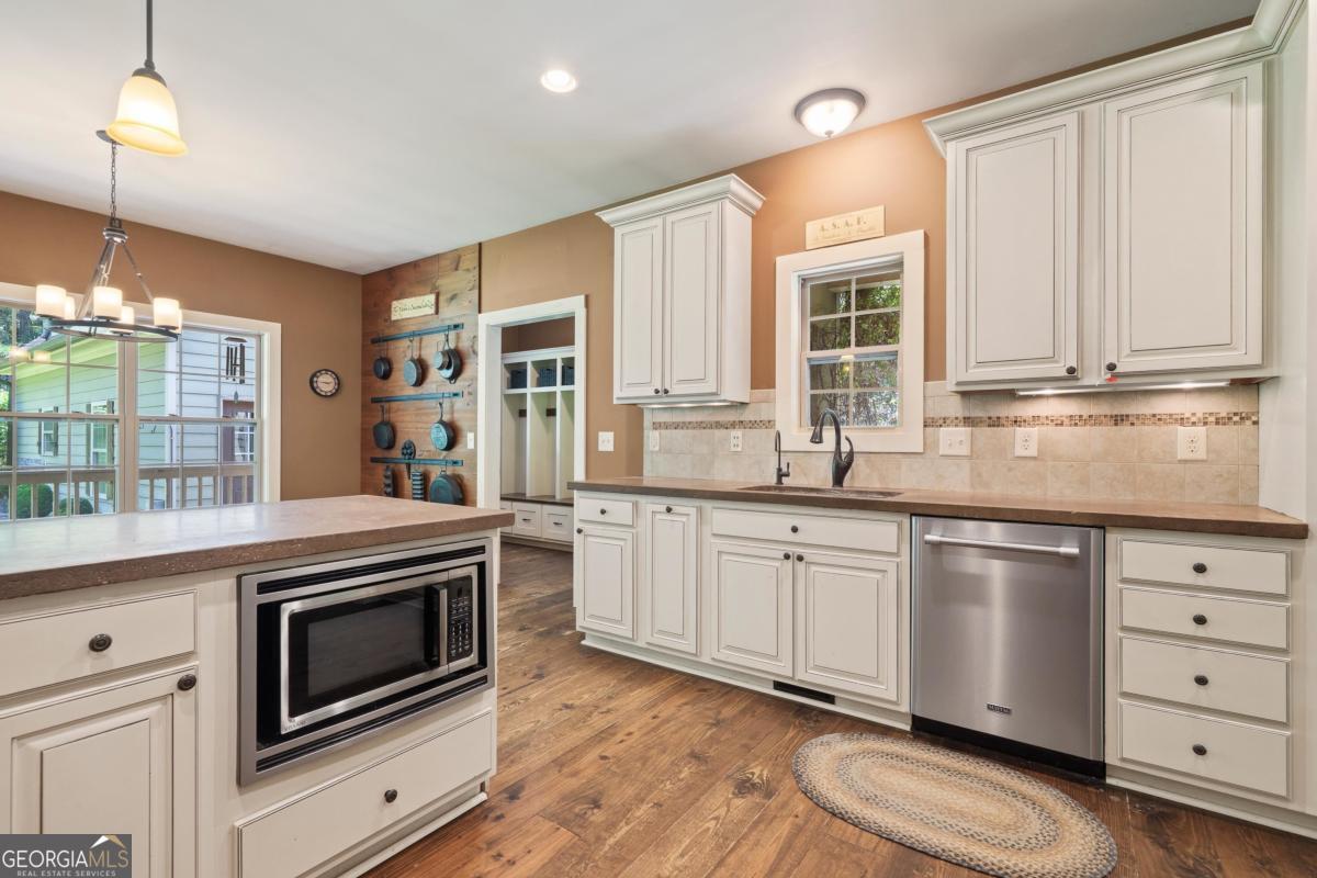 1991 Armour Bridge Road Greensboro, GA 30642 - Photo 13 of 41 a kitchen with granite countertop cabinets stainless steel appliances and a window