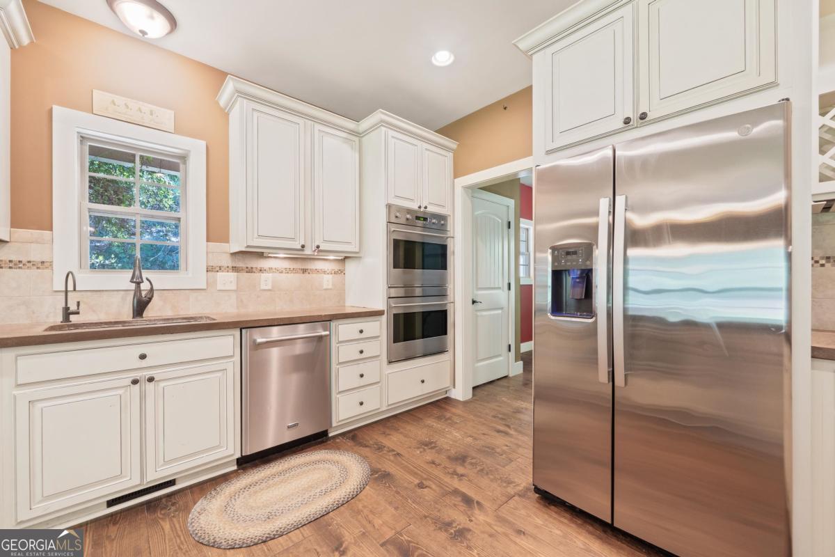 1991 Armour Bridge Road Greensboro, GA 30642 - Photo 14 of 41 a kitchen with stainless steel appliances a refrigerator sink and cabinets