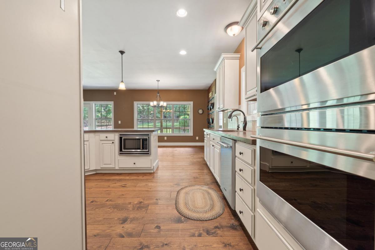 1991 Armour Bridge Road Greensboro, GA 30642 - Photo 15 of 41 a view of a kitchen with microwave and stove