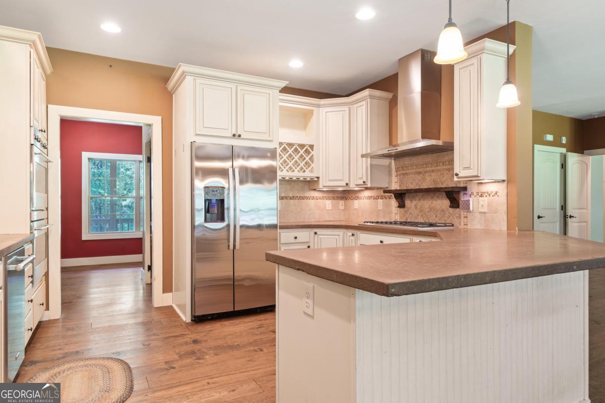 1991 Armour Bridge Road Greensboro, GA 30642 - Photo 16 of 41 a kitchen with stainless steel appliances granite countertop a sink a stove and a refrigerator