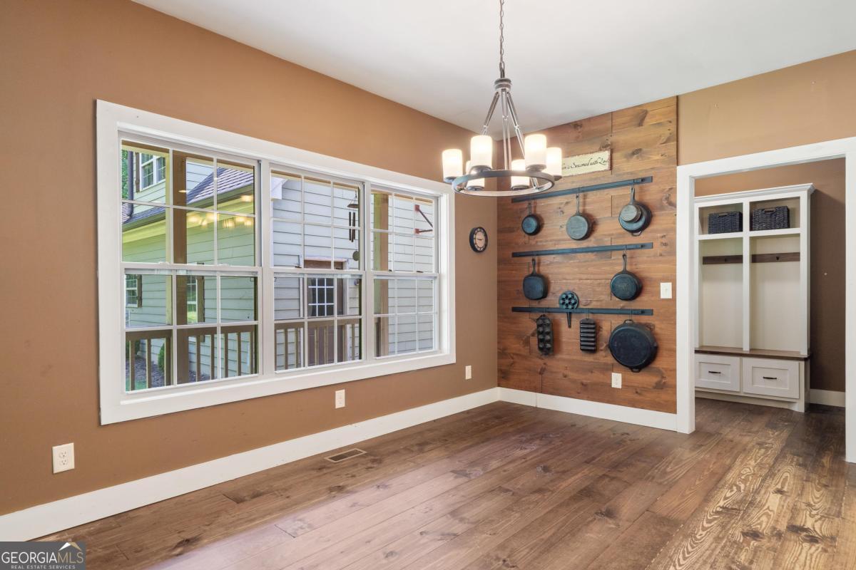 1991 Armour Bridge Road Greensboro, GA 30642 - Photo 18 of 41 a view of an empty room with wooden floor and windows