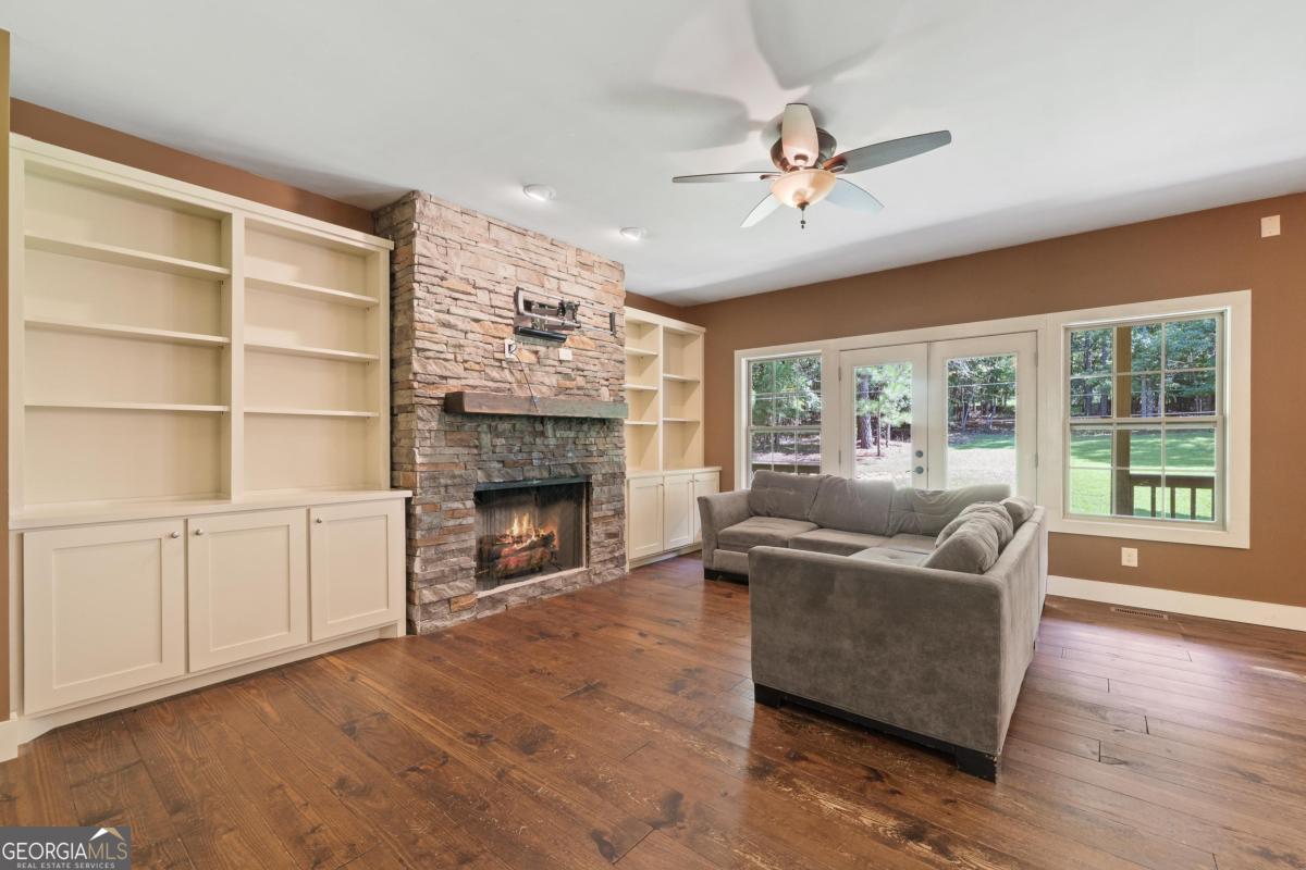 1991 Armour Bridge Road Greensboro, GA 30642 - Photo 21 of 41 a living room with furniture and a fireplace
