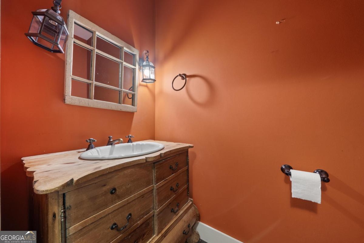 1991 Armour Bridge Road Greensboro, GA 30642 - Photo 24 of 41 a bathroom with a sink and a mirror