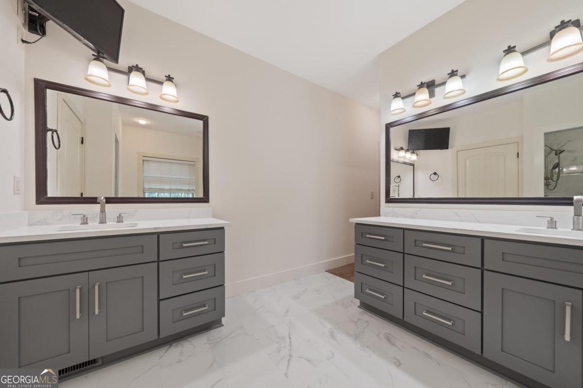1991 Armour Bridge Road Greensboro, GA 30642 - Photo 29 of 41 a bathroom with a double vanity sink and a mirror