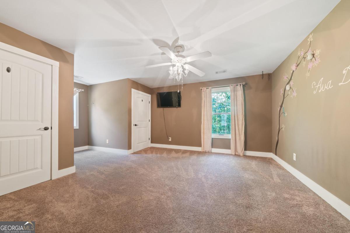 1991 Armour Bridge Road Greensboro, GA 30642 - Photo 30 of 41 a view of a big room with windows and chandelier fan