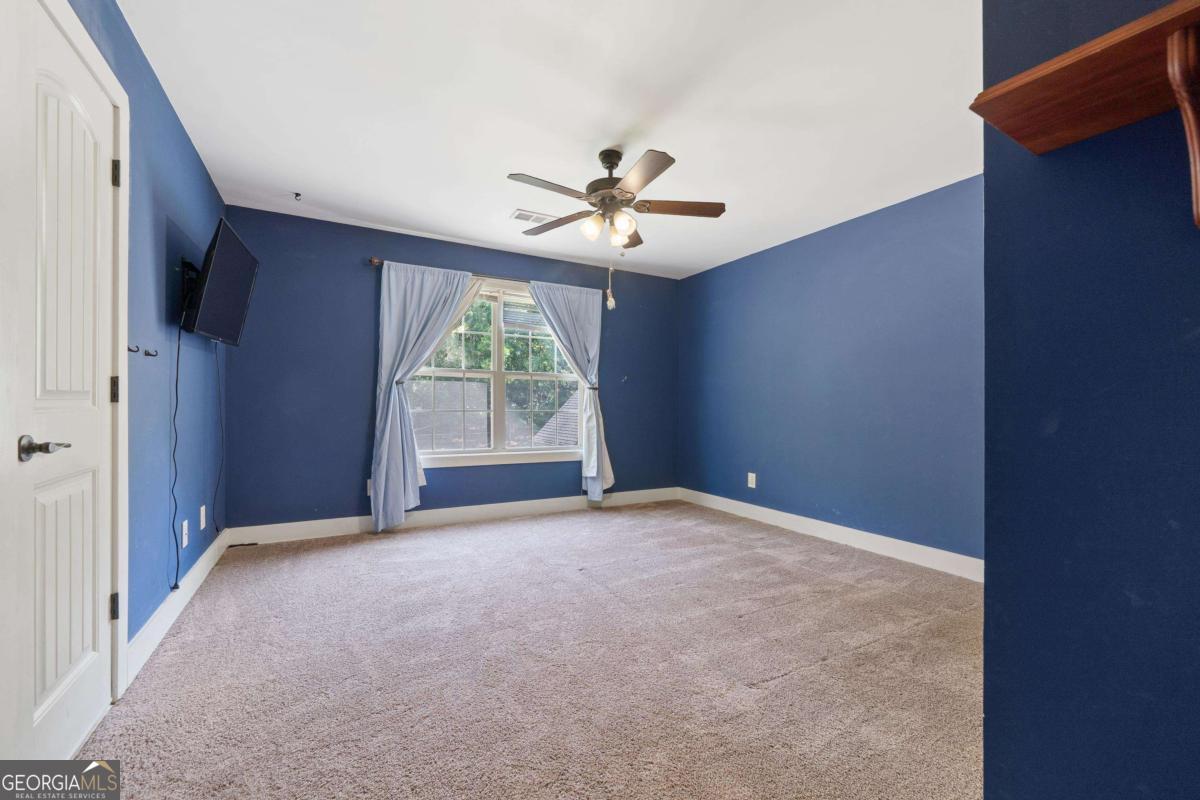 1991 Armour Bridge Road Greensboro, GA 30642 - Photo 32 of 41 an empty room with windows and ceiling fan