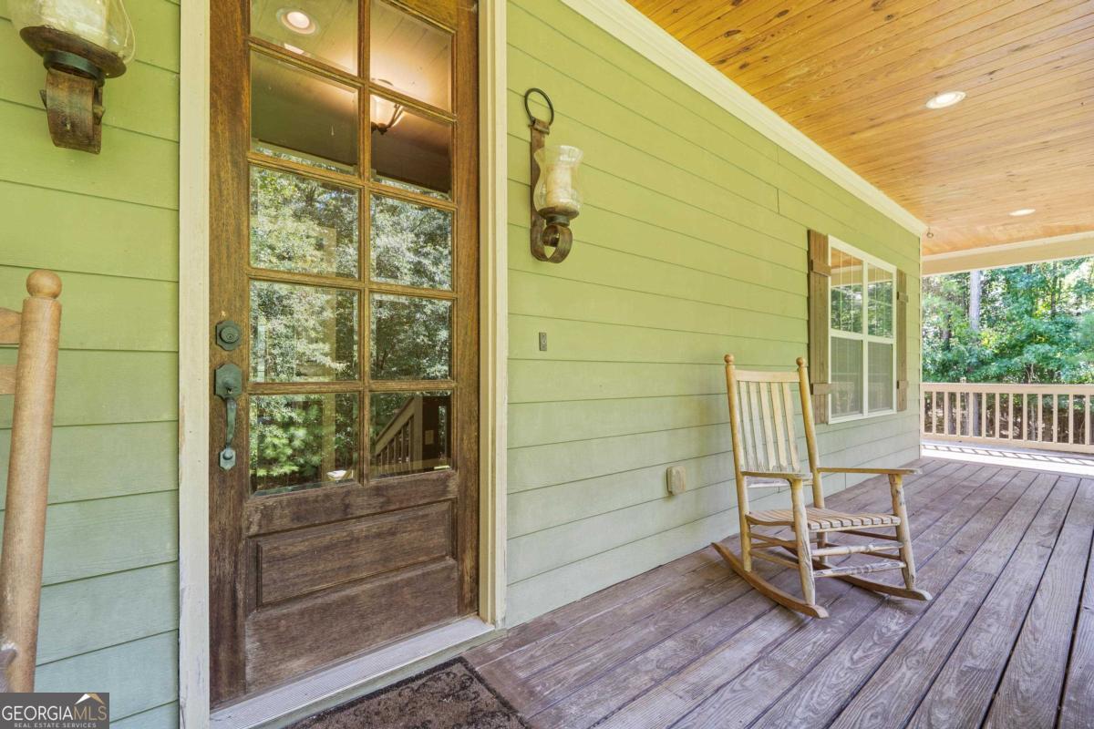1991 Armour Bridge Road Greensboro, GA 30642 - Photo 5 of 41 a view of a balcony with a chair and wooden floor