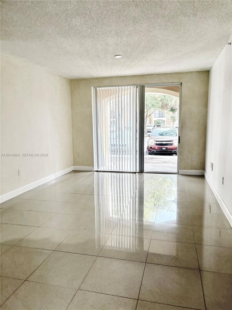 8030 North Nob Hill Road, Unit 105 Tamarac, FL 33321 - Photo 6 of 22 a view of empty room with cabinet and floor to ceiling window