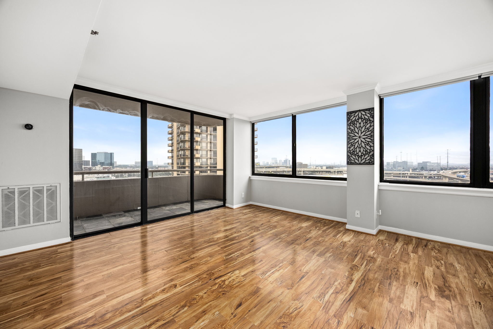3525 Sage Road, Unit 1409 Houston, TX 77056 - Photo 17 of 45 a view of an empty room with a window and wooden floor