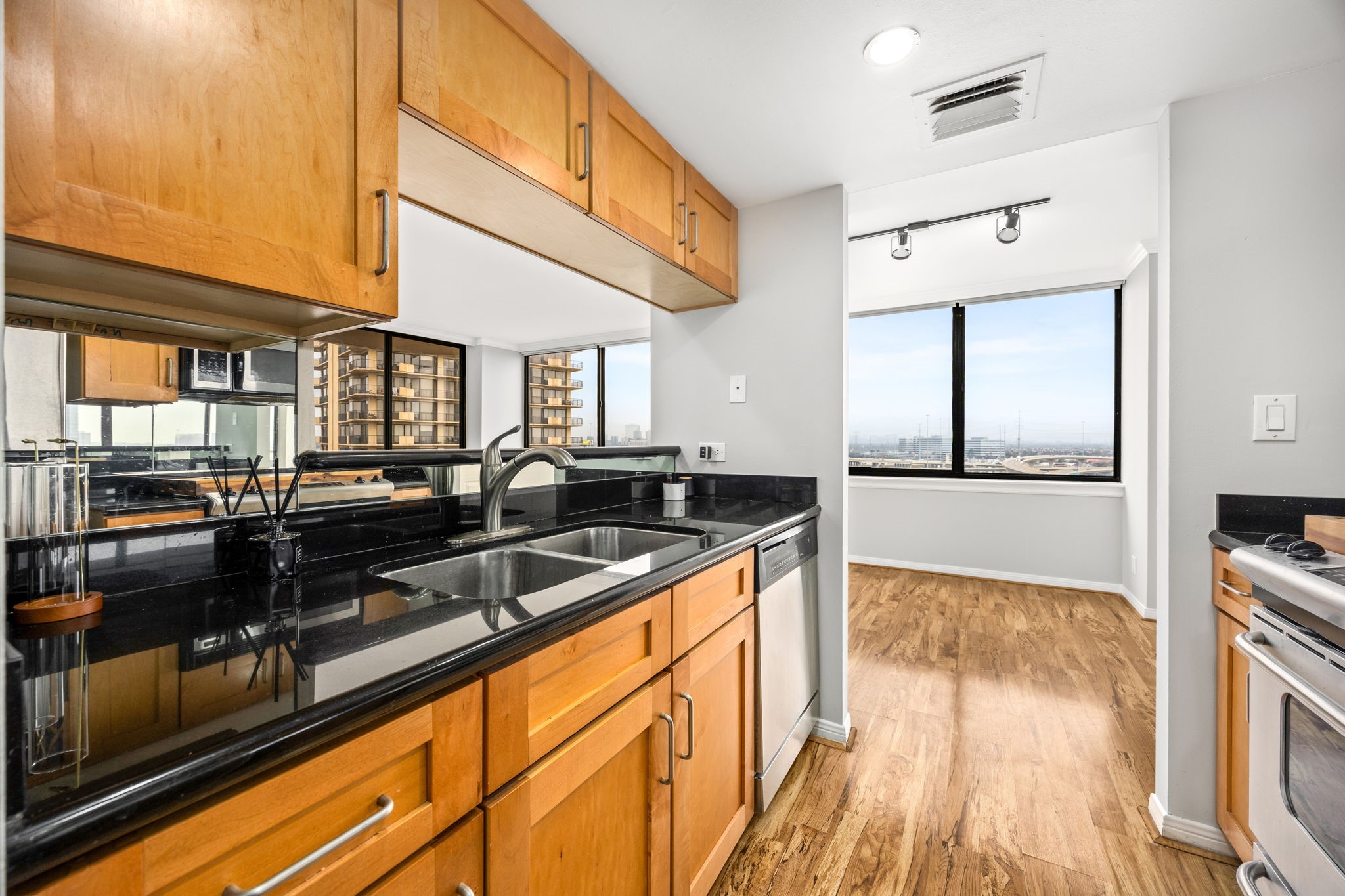 3525 Sage Road, Unit 1409 Houston, TX 77056 - Photo 28 of 45 a kitchen with granite countertop a sink and a stove top oven