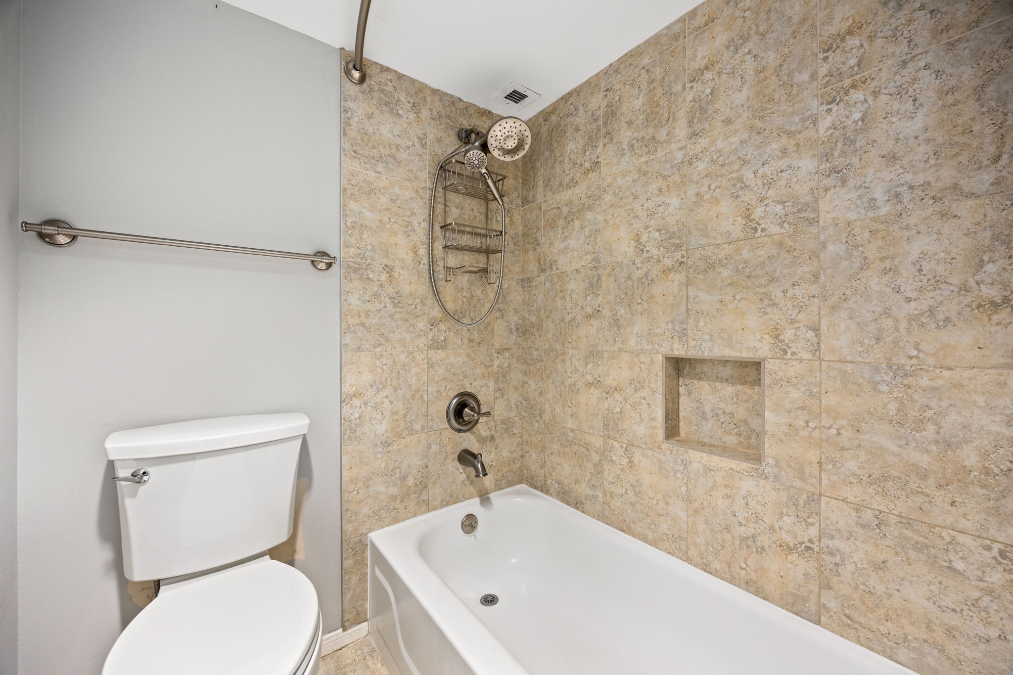 3525 Sage Road, Unit 1409 Houston, TX 77056 - Photo 33 of 45 a white toilet sitting next to a bath tub and a shower