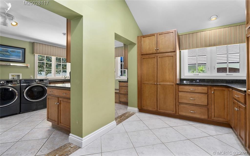 22 East High Point Road Stuart, FL 34996 - Photo 41 of 84 a kitchen with a refrigerator sink and cabinets