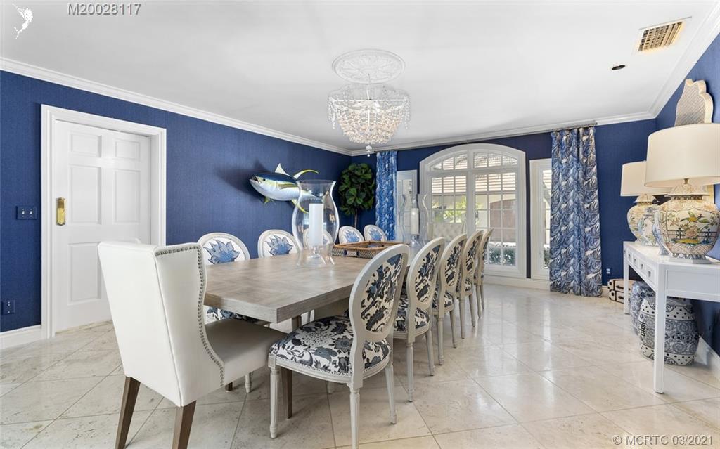 22 East High Point Road Stuart, FL 34996 - Photo 44 of 84 a view of a dining room with furniture and chandelier