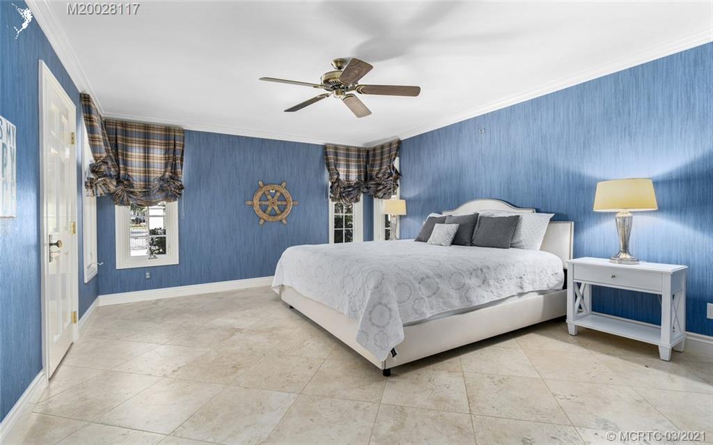 22 East High Point Road Stuart, FL 34996 - Photo 45 of 84 a bedroom with a bed wall painting and a window