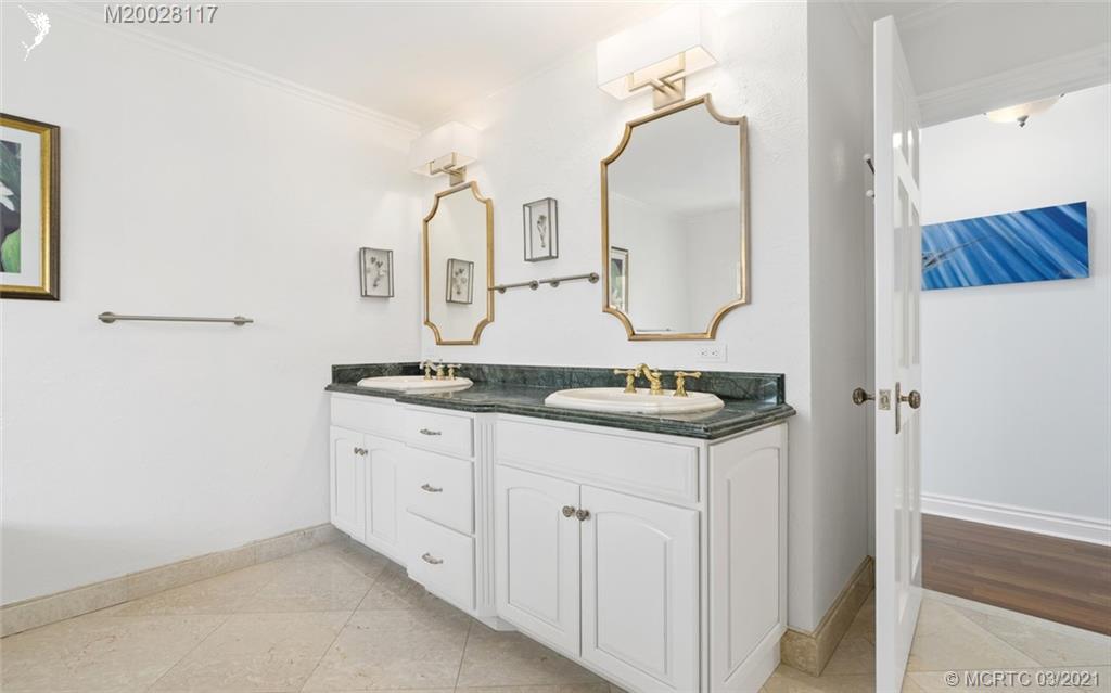 22 East High Point Road Stuart, FL 34996 - Photo 49 of 84 a bathroom with a double vanity sink and mirror