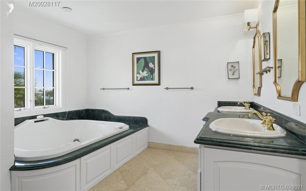 22 East High Point Road Stuart, FL 34996 - Photo 52 of 84 a bathroom with a sink and a bathtub