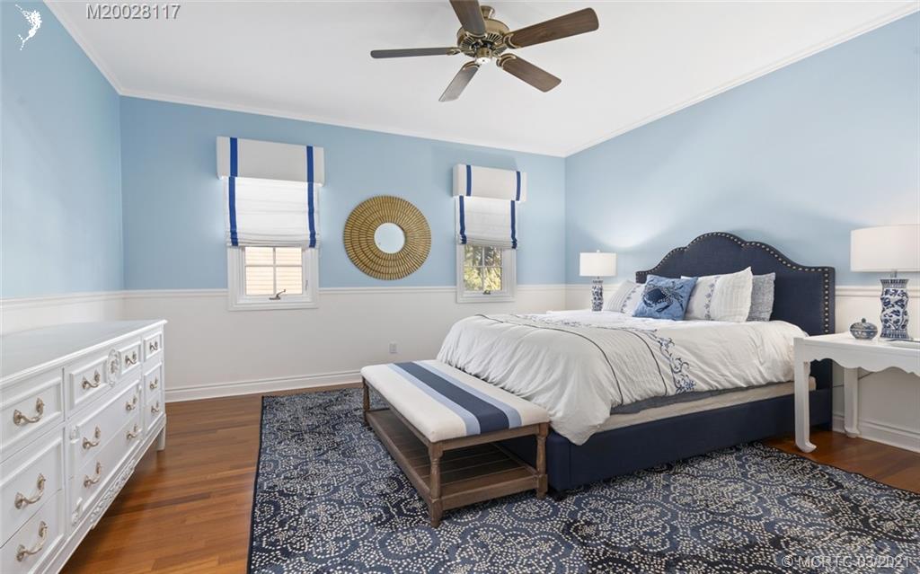 22 East High Point Road Stuart, FL 34996 - Photo 62 of 84 a bedroom with a bed and a chandelier