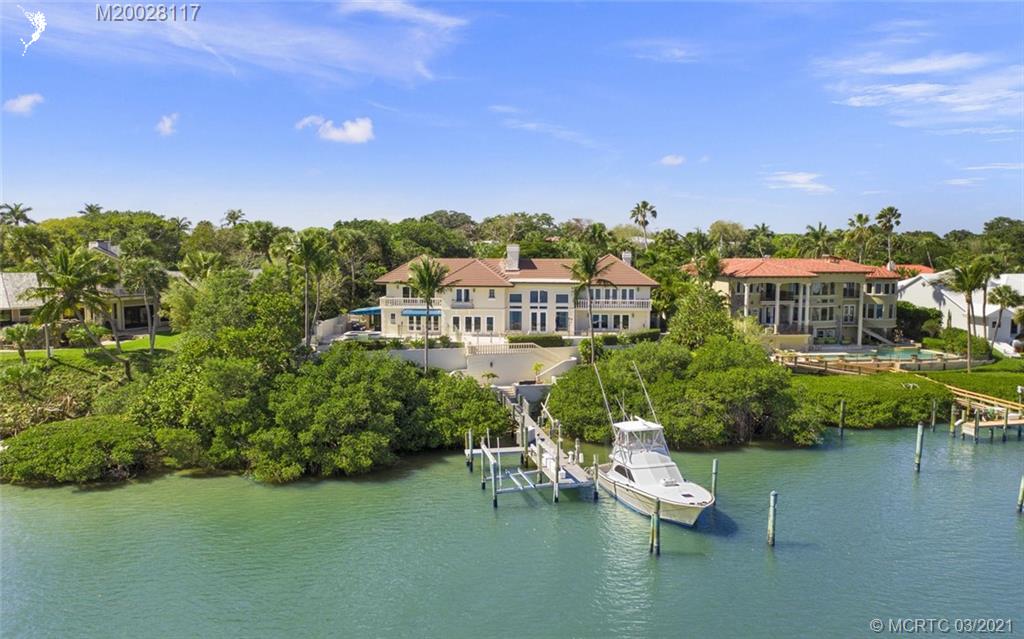 22 East High Point Road Stuart, FL 34996 - Photo 80 of 84 a view of a lake with a house in the background