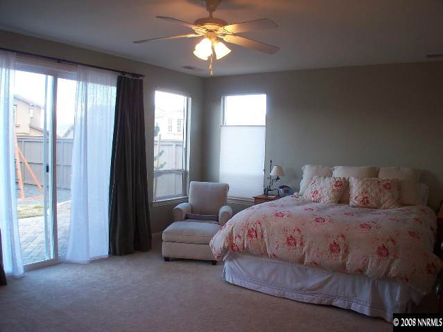 620 Ubaldo Court Reno, NV 89521 - Photo 4 of 9 a bedroom with a bed and a chandelier