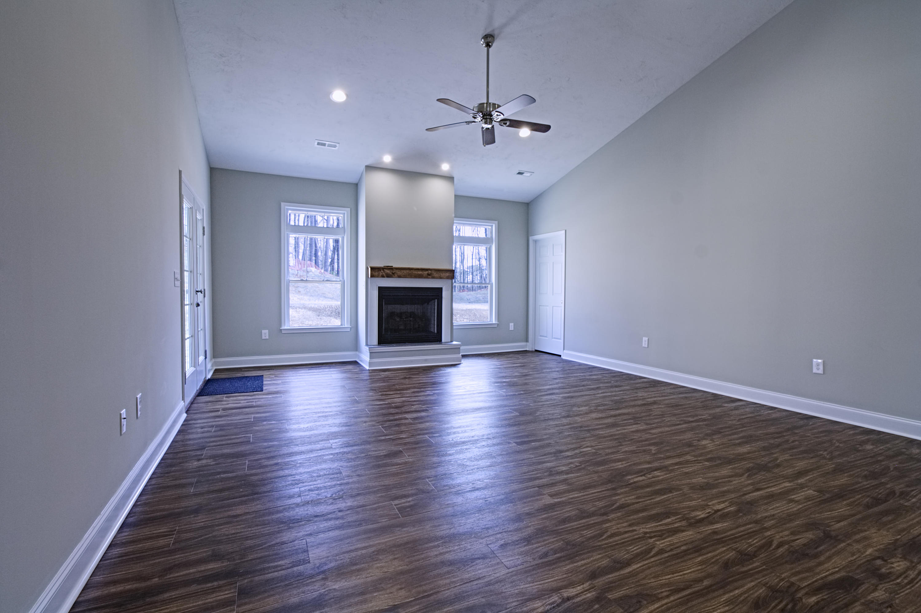 4281 Daugherty Road Salem, VA 24153 - Photo 3 of 21 an empty room with wooden floor fireplace and windows