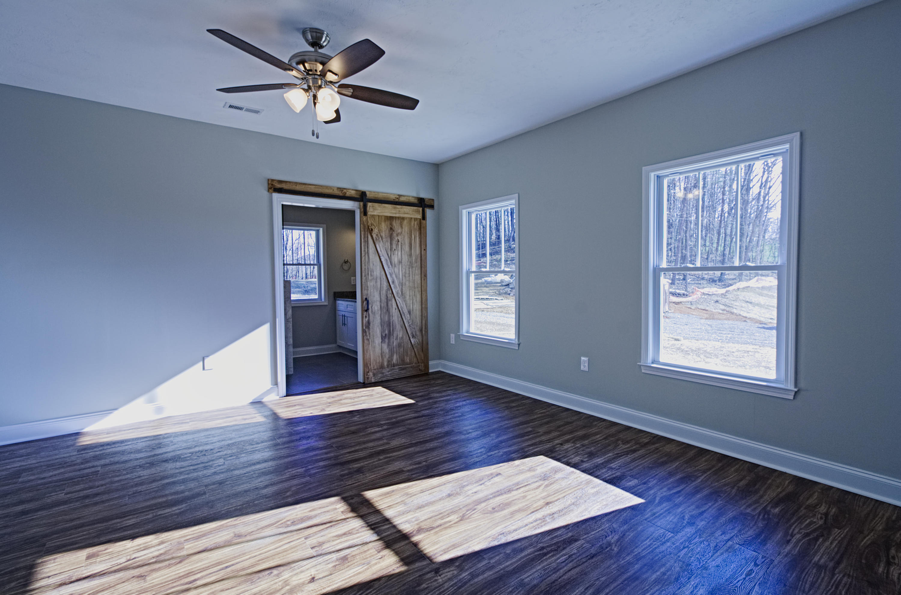 4281 Daugherty Road Salem, VA 24153 - Photo 7 of 21 a view of an empty room with wooden floor and a ceiling fan