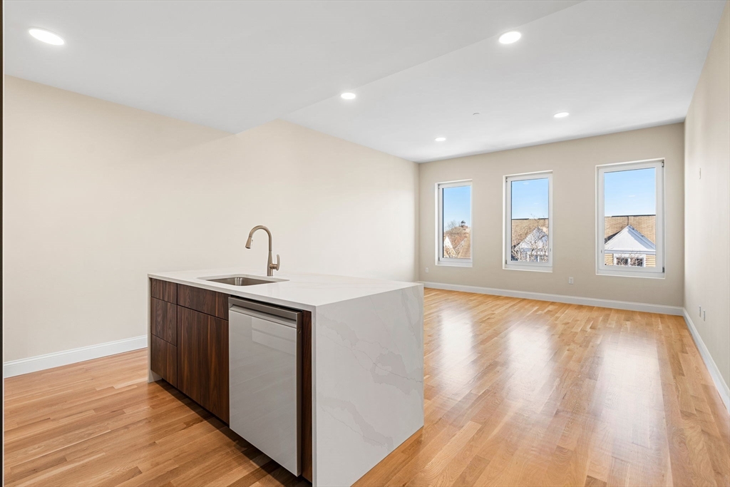 16 Taber Street, Unit 304 Boston, MA 02119 - Photo 11 of 11 a view of an empty room with wooden floor and a window